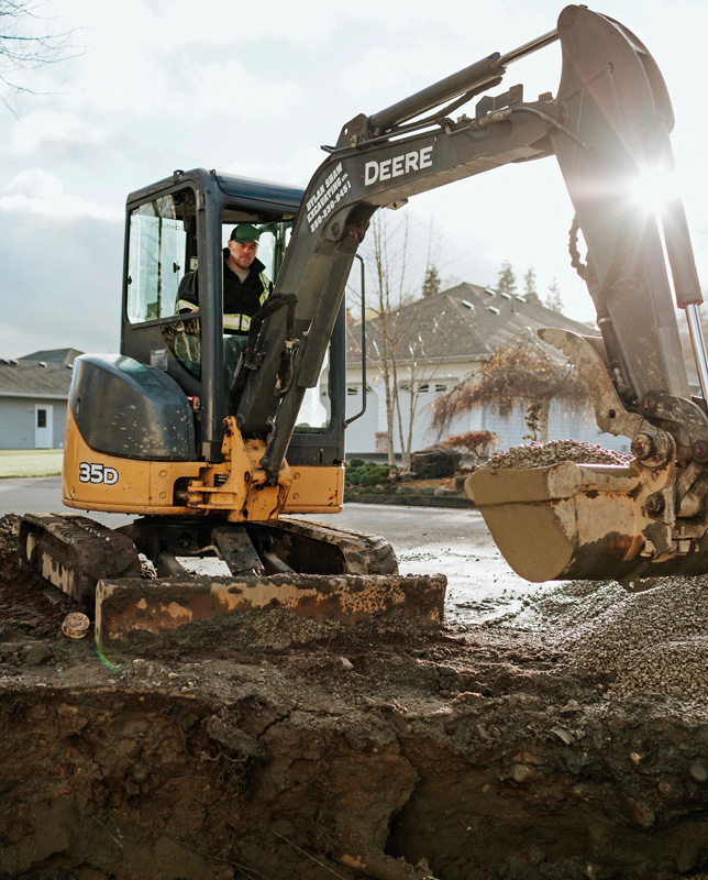 Dylan Shaw running excavator in Port Hardy digging holes
