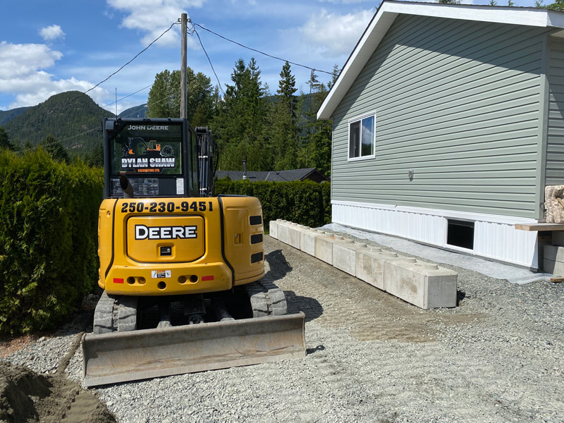 Dylan Shaw Excavating laying retaining wall and grading parking lot in Northern Vancouver Island