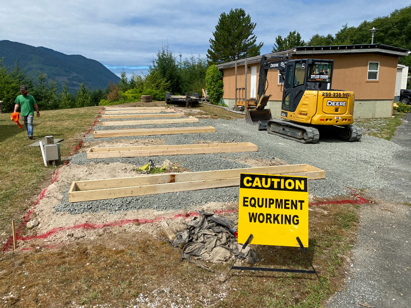 excavator operator creating mobile home footings in Northern Vancouver Island