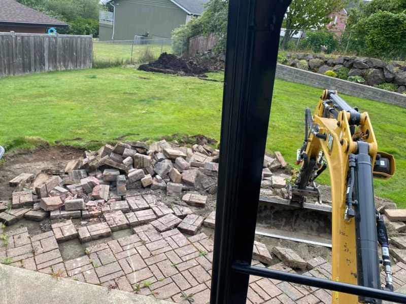 Dylan Shaw Excavating removing brick from limited access backyard