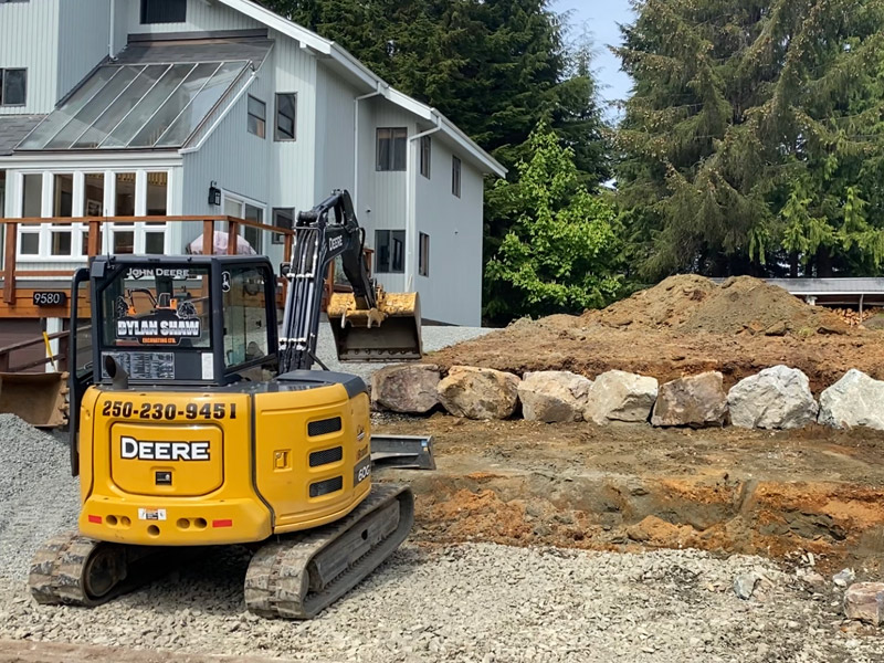Dylan Shaw Excavating, landscaping and laying retaining wall in Port Hardy